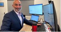 Stephen Ferrara, DNP, sitting at desk